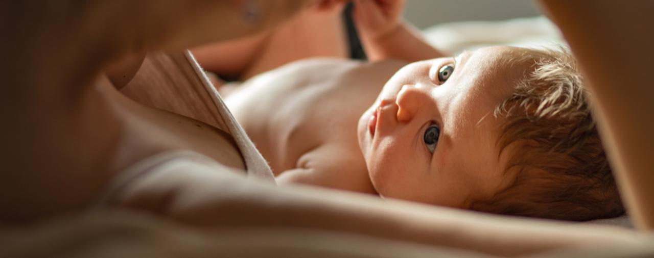 Baby gazing up from a parent's arms