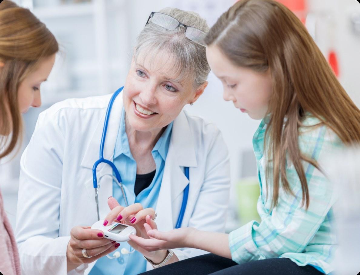 Pediatrician showing a handheld health device to a young patient